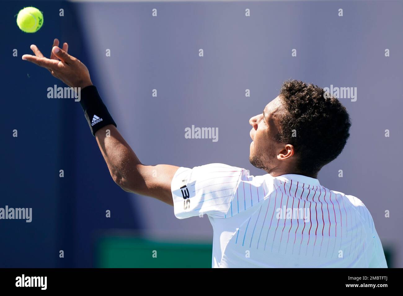 Felix AugerAliassime, of Canada, serves to Miomir Kecmanovic, of