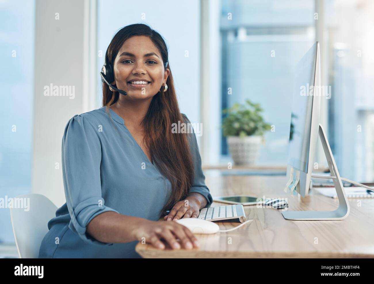 Shes a pro at fielding dozens of inquiries a day. Portrait of a young ...