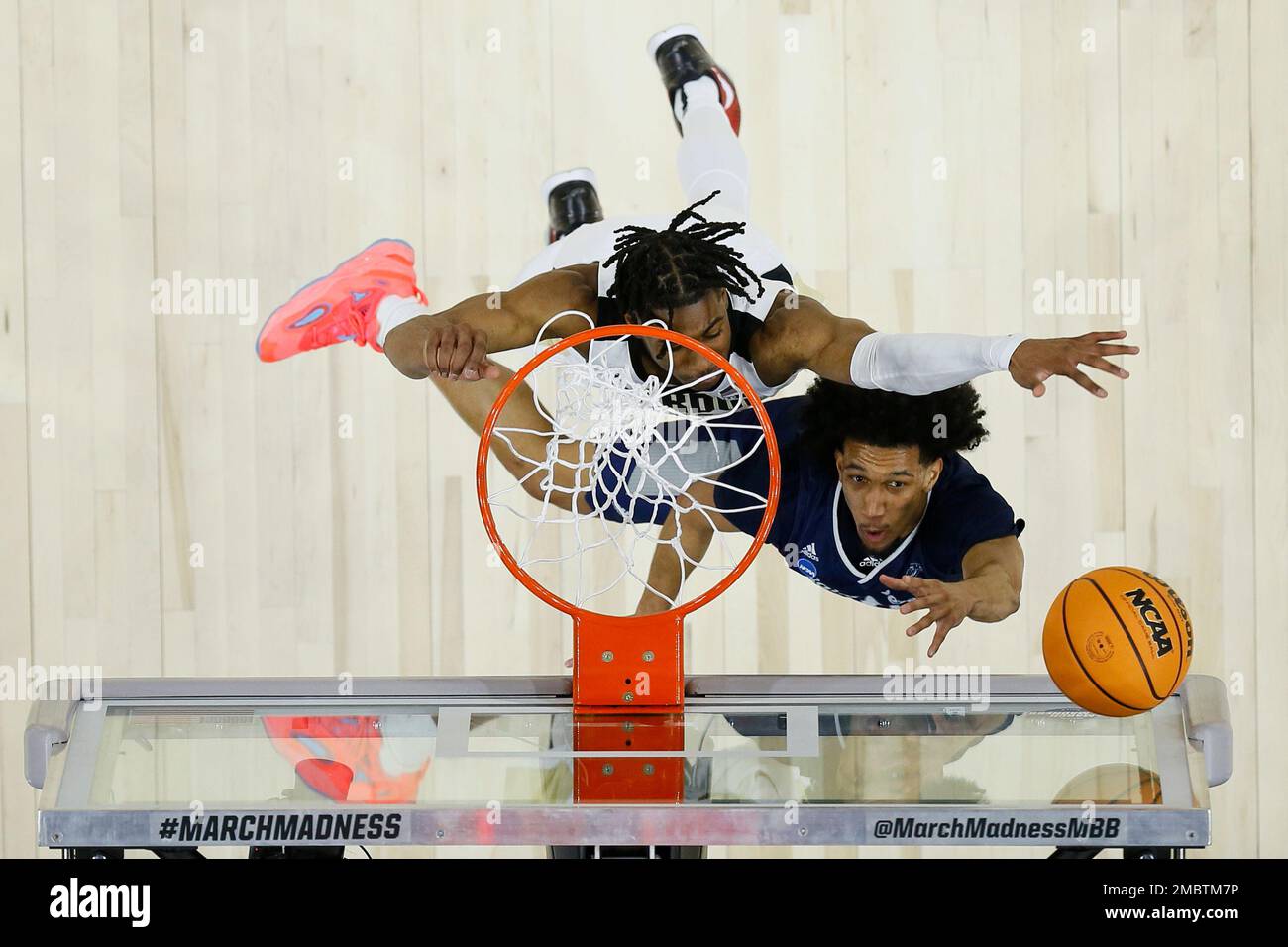 Saint Peter's Matthew Lee, bottom, goes up for a shot against Purdue's  Jaden Ivey during the first half of a college basketball game in the Sweet  16 round of the NCAA tournament,