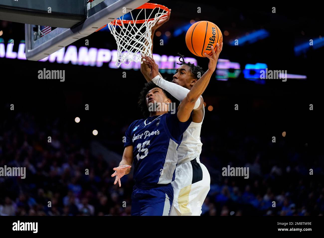 Saint Peter's Matthew Lee, left, goes up for a shot against Purdue's Jaden  Ivey during the first half of a college basketball game in the Sweet 16  round of the NCAA tournament,