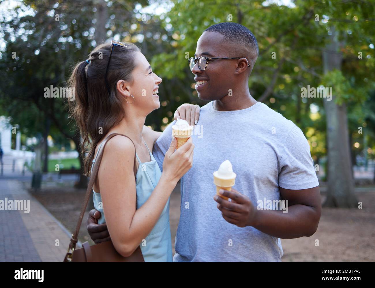 Love, ice cream or couple of friends hug in a park on a romantic date