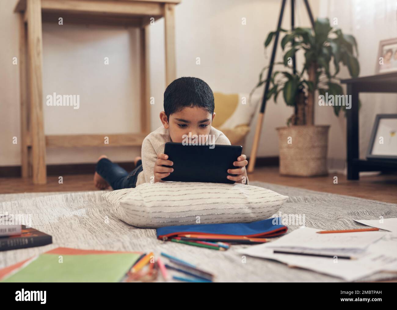 One smart app for one smart kid. an adorable little boy using a digital ...