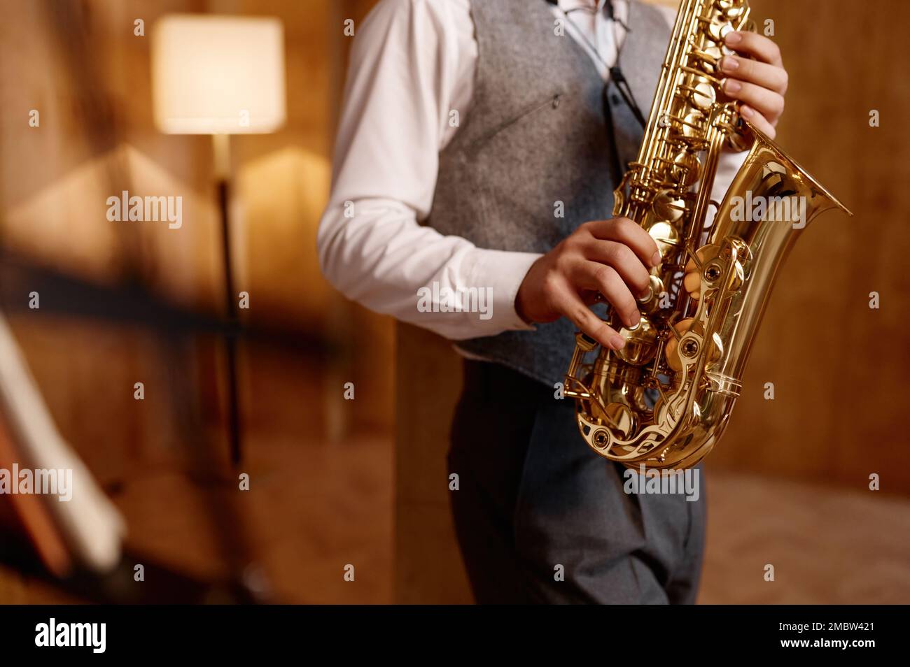 Cropped shot of young musician standing and playing saxophone Stock Photo