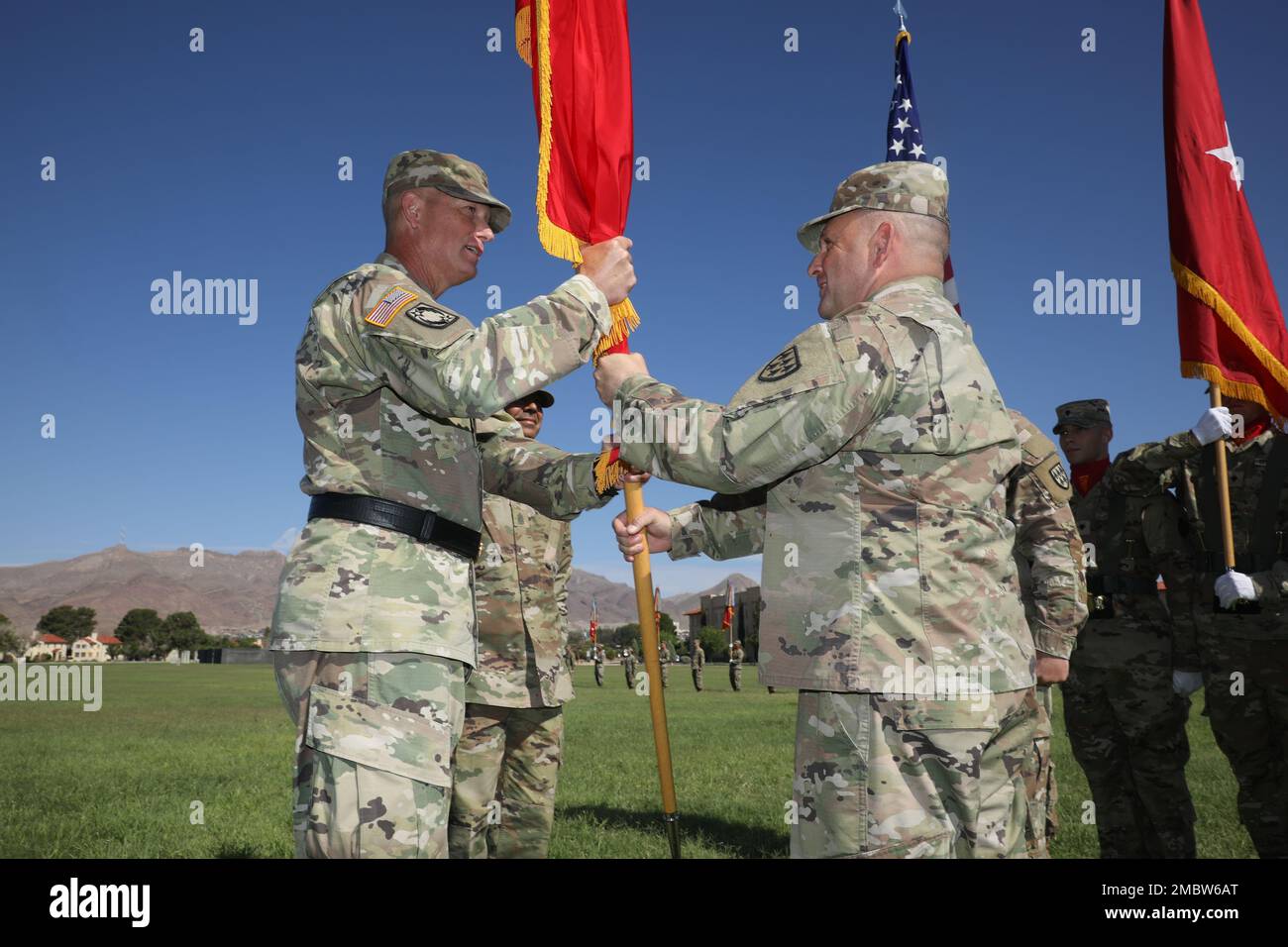 Command Sgt. Maj. Jerry Jacobitz passes the 32d Army Air and Missile Defense Command colors to Brig. Gen. David Stewart, commander, 32d AAMDC during a change of responsibility ceremony held June 23, at Noel Field, Fort Bliss, Texas where Jacobitz relinquished responsibility of the unit to Command Sgt. Maj. Raymond Belk. Jacobitz, who joined the Army in 1992 as an infantryman, and who later in 1997 reclassified to become a Patriot Launcher Advance Operator/Maintainer will be also retire after over 30 years of service. Stock Photo