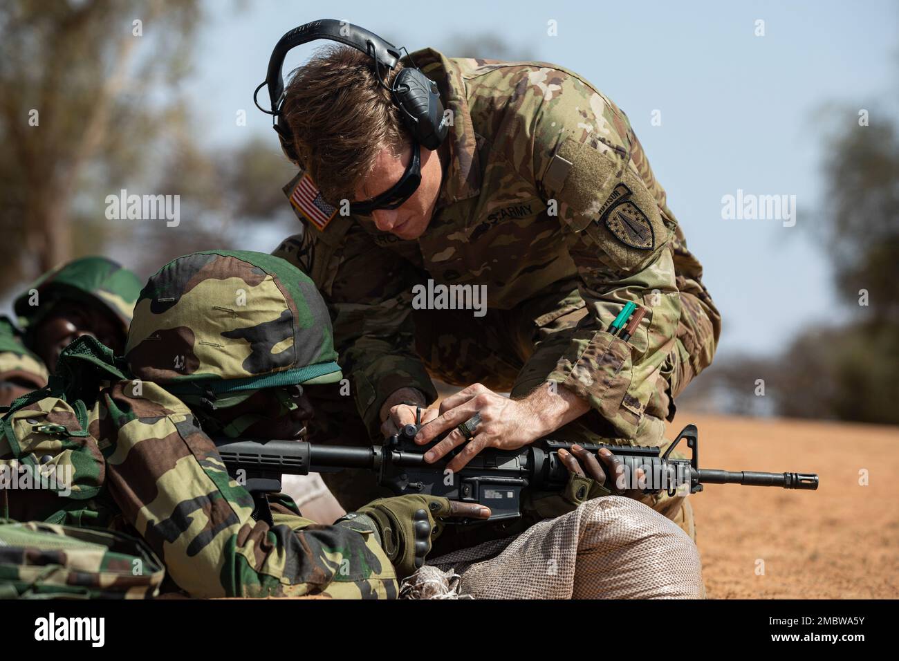 U.S. Army Sgt. 1st Class Andrew Pierce, with Maneuver Company Advisor Team, 2nd Security Forces Assistance Brigade, adjusts an M-4 Carbine during African Lion 22 in Dodji, Senegal, June 22, 2022. African Lion 22 is U.S. Africa Command’s largest, premier, joint, annual exercise hosted by Morocco, Ghana, Senegal and Tunisia, June 6-30. More than 7,500 participants from 28 nations and NATO train together with a focus on enhancing readiness for U.S. and partner nation forces. AL22 is a joint all-domain, multi-component and multinational exercise, employing a full array of mission capabilities with Stock Photo