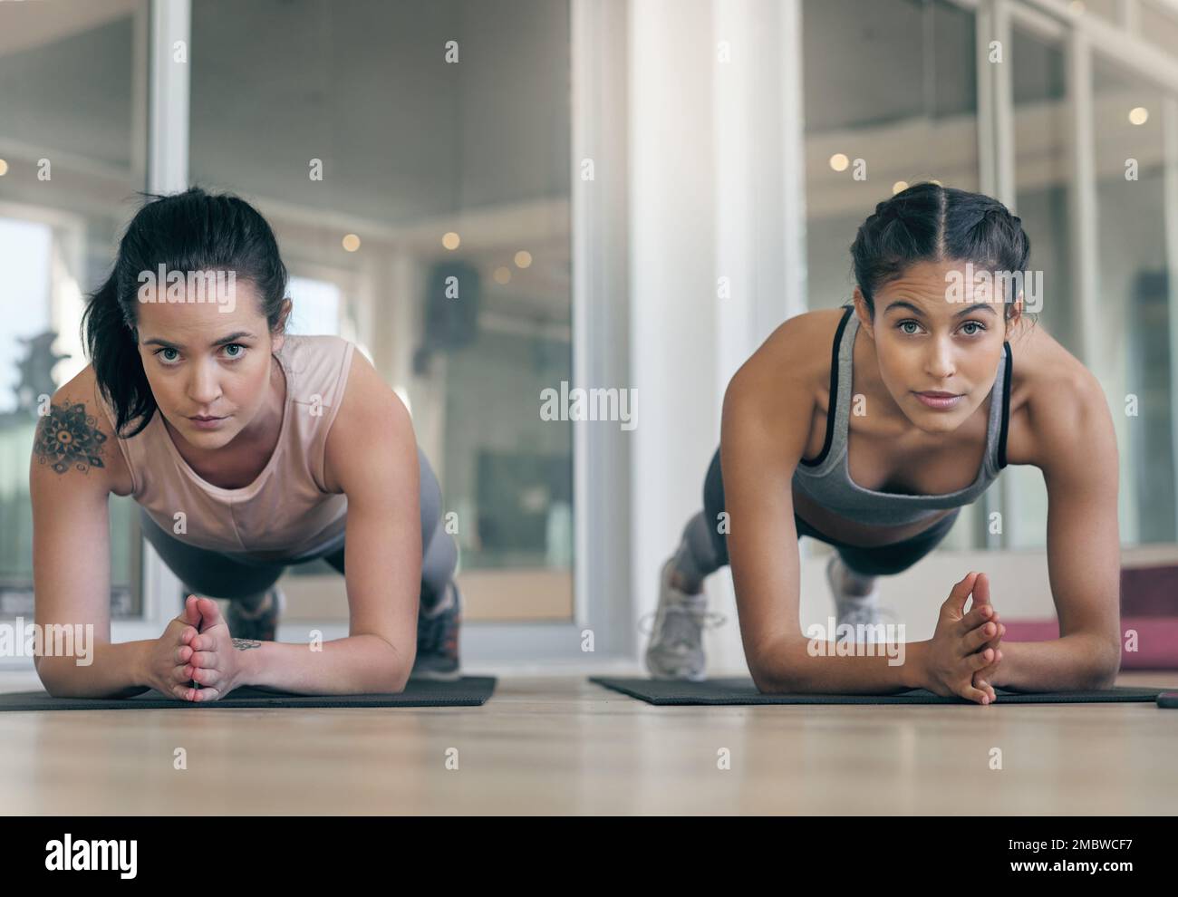 How long will you last. two young athletes working out together at the gym. Stock Photo