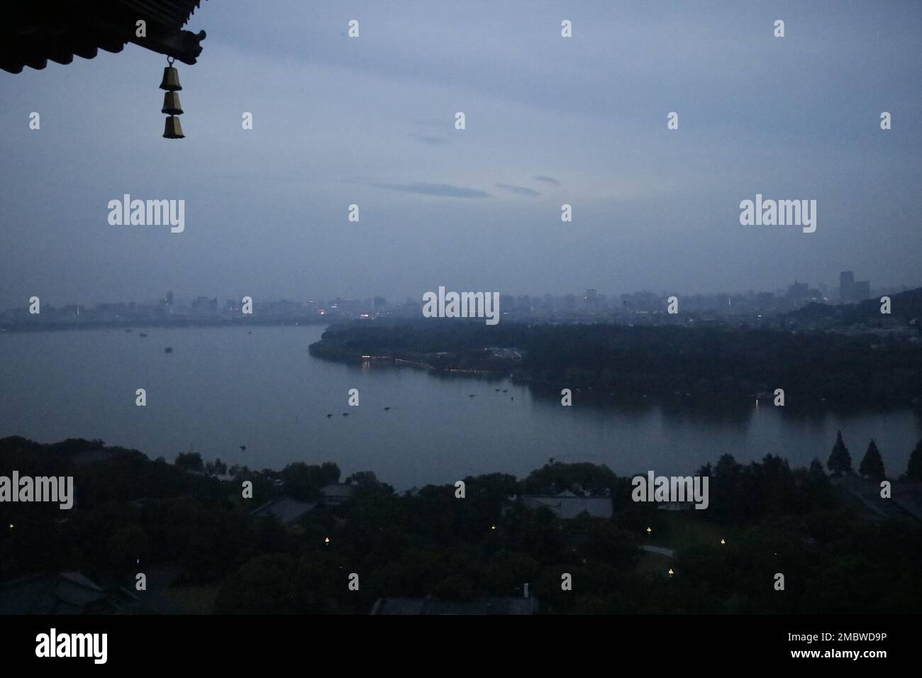 A dramatic shot of Powai lake with the buildings in the background on a foggy day Stock Photo