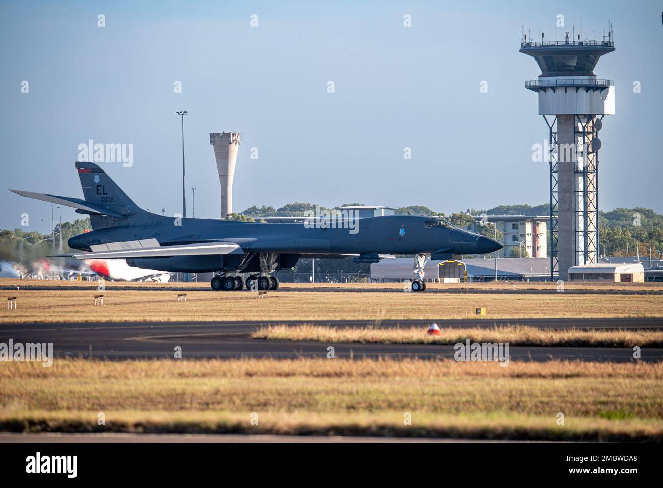 A U.S. Air Force B-1B Lancer assigned to the 34th Expeditionary Bomb Squadron, Ellsworth Air Force Base, South Dakota, taxies past the Darwin airport control tower on its way to the Royal Australian Air Force base to take on fuel in Darwin, Northern Territory, Australia, June 22, 2022. Bomber missions contribute to joint force lethality and deter aggression in the Indo-Pacific by demonstrating United States Air Force ability to operate anywhere in the world at any time in support of the National Defense Strategy. Stock Photo