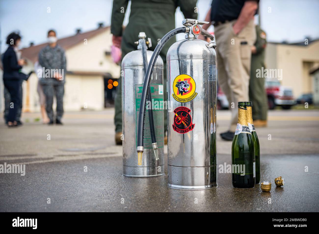 Tanks filled with water and champagne bottles sit along the flightline after being used to spray U.S. Air Force Col. Jesse J. Friedel, 35th Fighter Wing commander, after his fini-flight at Misawa Air Base, Japan, June 22, 2022. A final flight, or fini-flight, is a USAF tradition, to celebrate one’s last flight with their unit, by spraying champagne, making a toast and dowsing water from a fire truck onto the aircraft and aircrew. Stock Photo