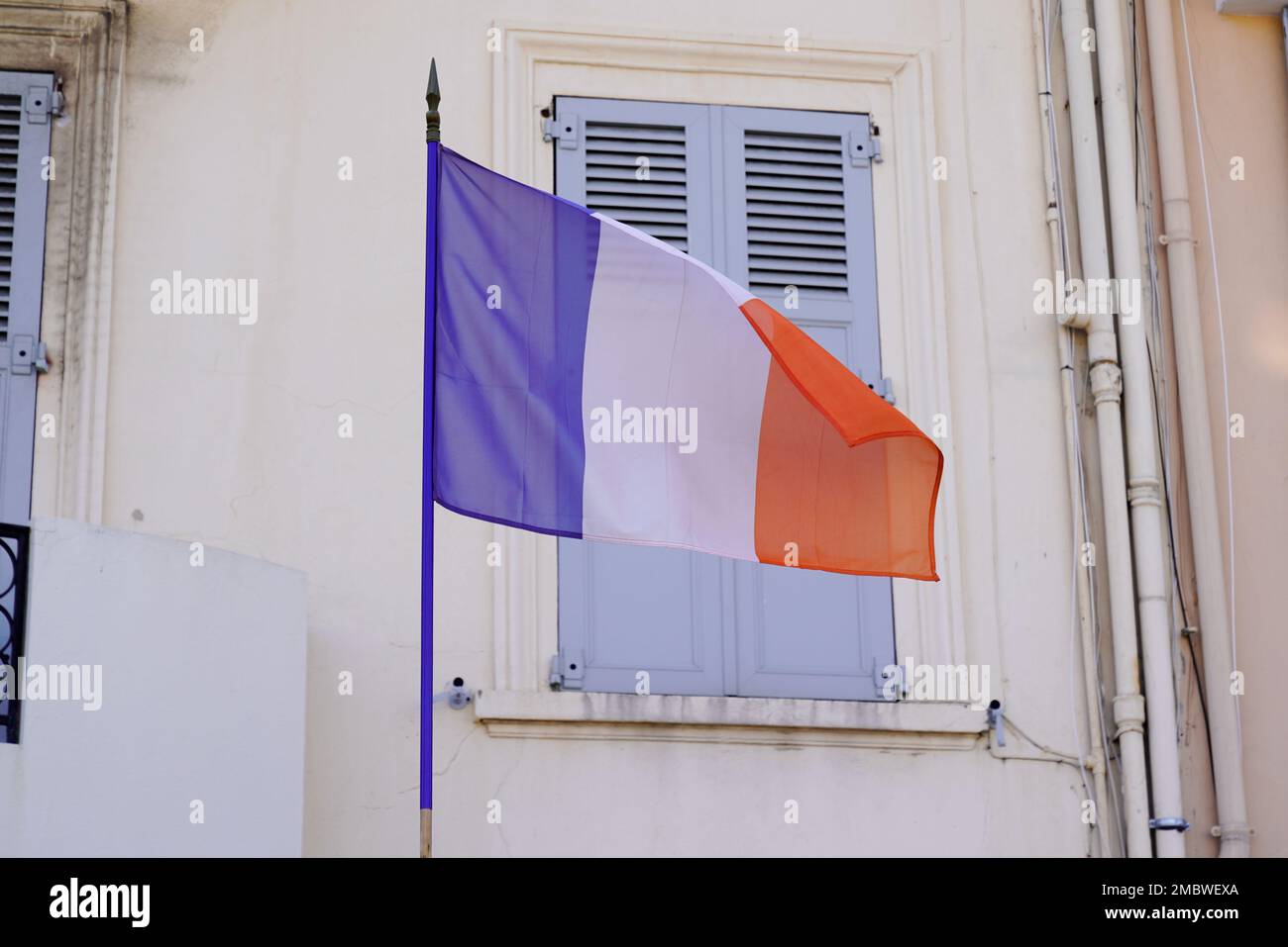 French tricolors blue white red flag waving front city hall on mat