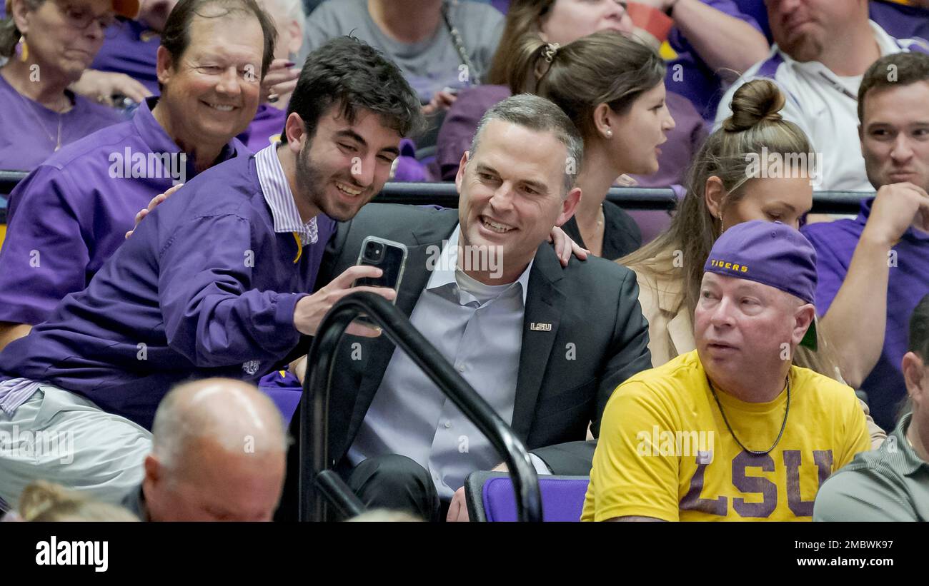 Former Murray State head coach Matt McMahon, center, poses with a fan after being hired as the head men's basketball coach for LSU during the second half of a women's college basketball Former Murray State head coach Matt McMahon, center, poses with a fan after being hired as the head men's basketball coach for LSU during the second half of a women's college basketball