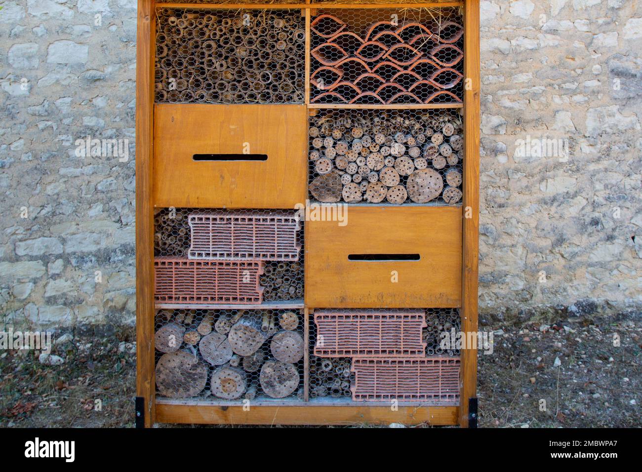 insect hut hotel french text in wooden house for butterfly bee and animals Stock Photo