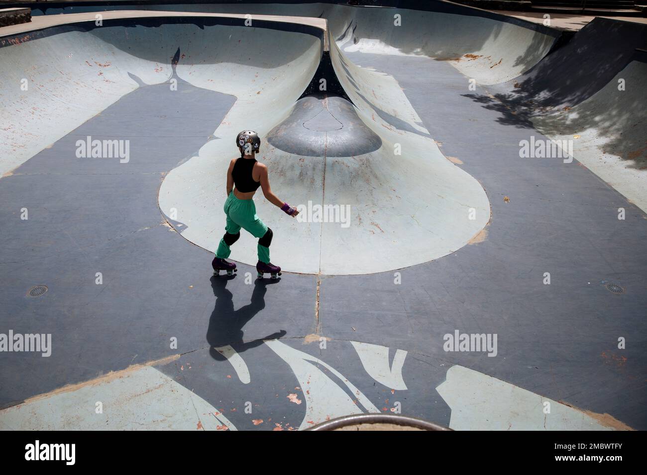 A woman perform freestyle rollerskating in a skatepark in SaintDenis