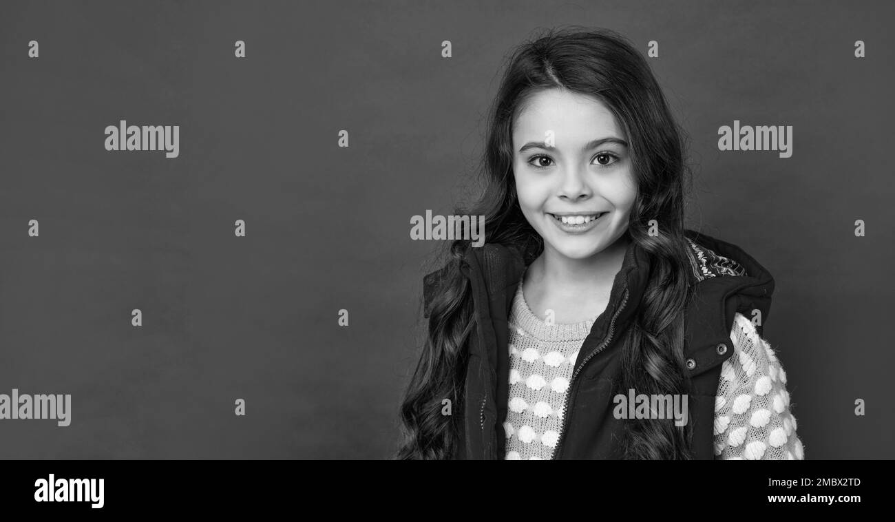 female fashion model. teen girl in down vest. face portrait of child