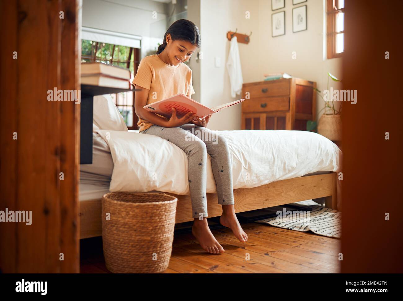 Happy child reading on bed for home learning, language education and