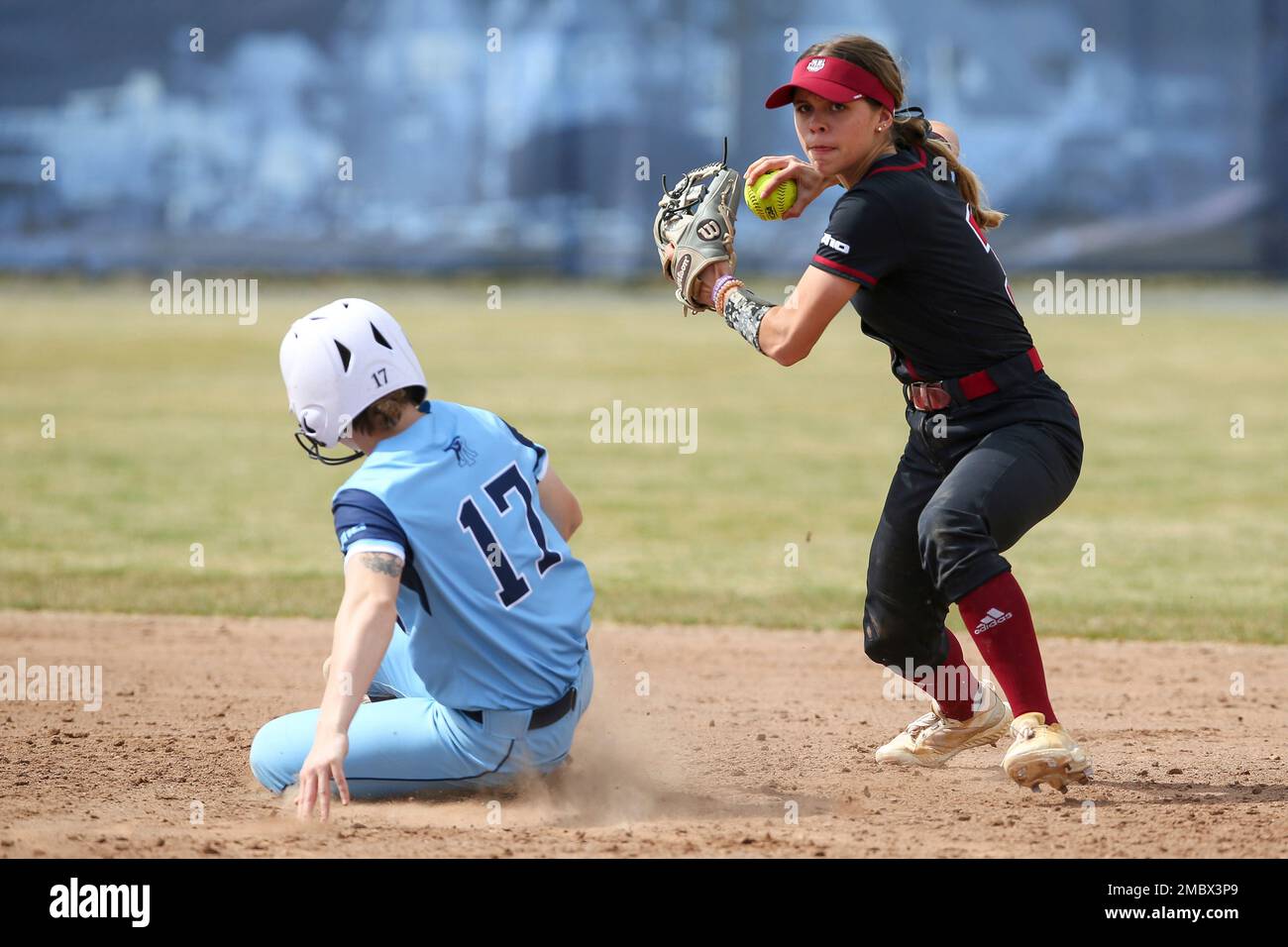 Massachusetts' Abby Packard (3) tags the base for a force out of Rhode Island's Katie Heenan (17
