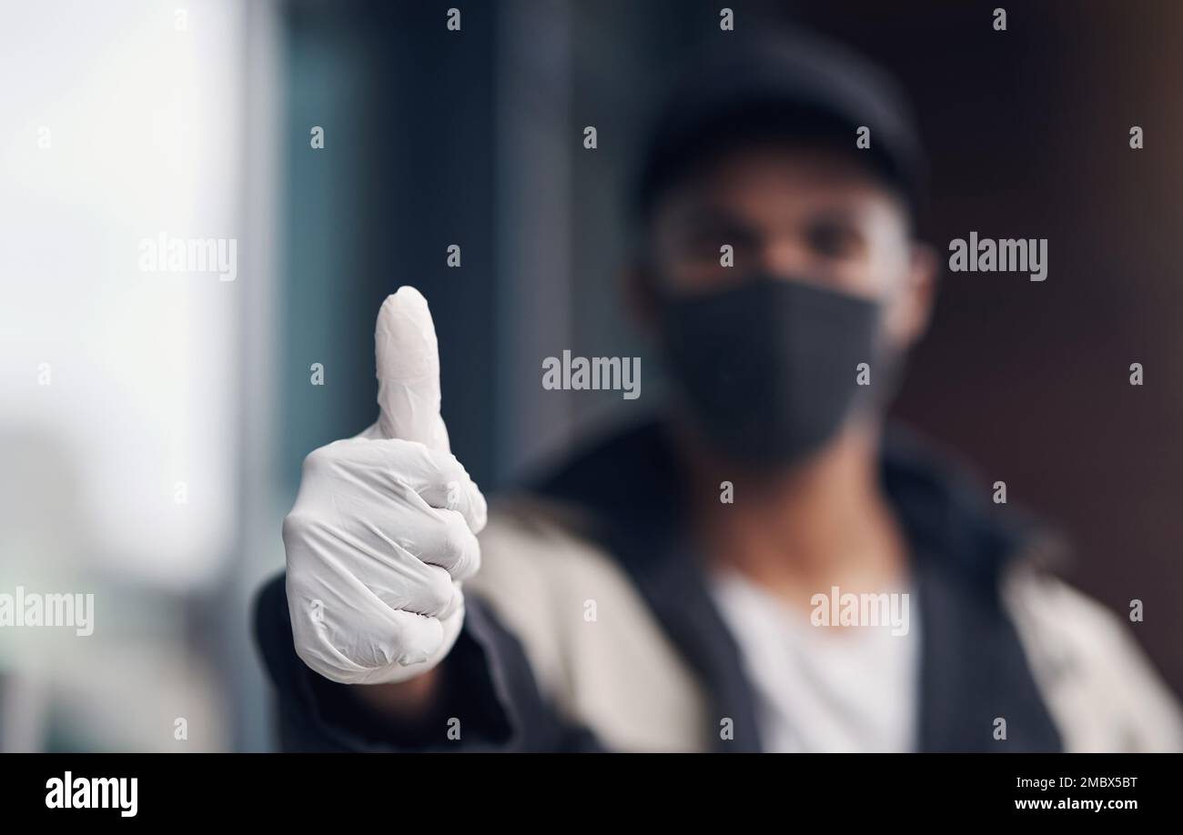Maintaining hygiene is a must for us. a masked young man showing thumbs ...