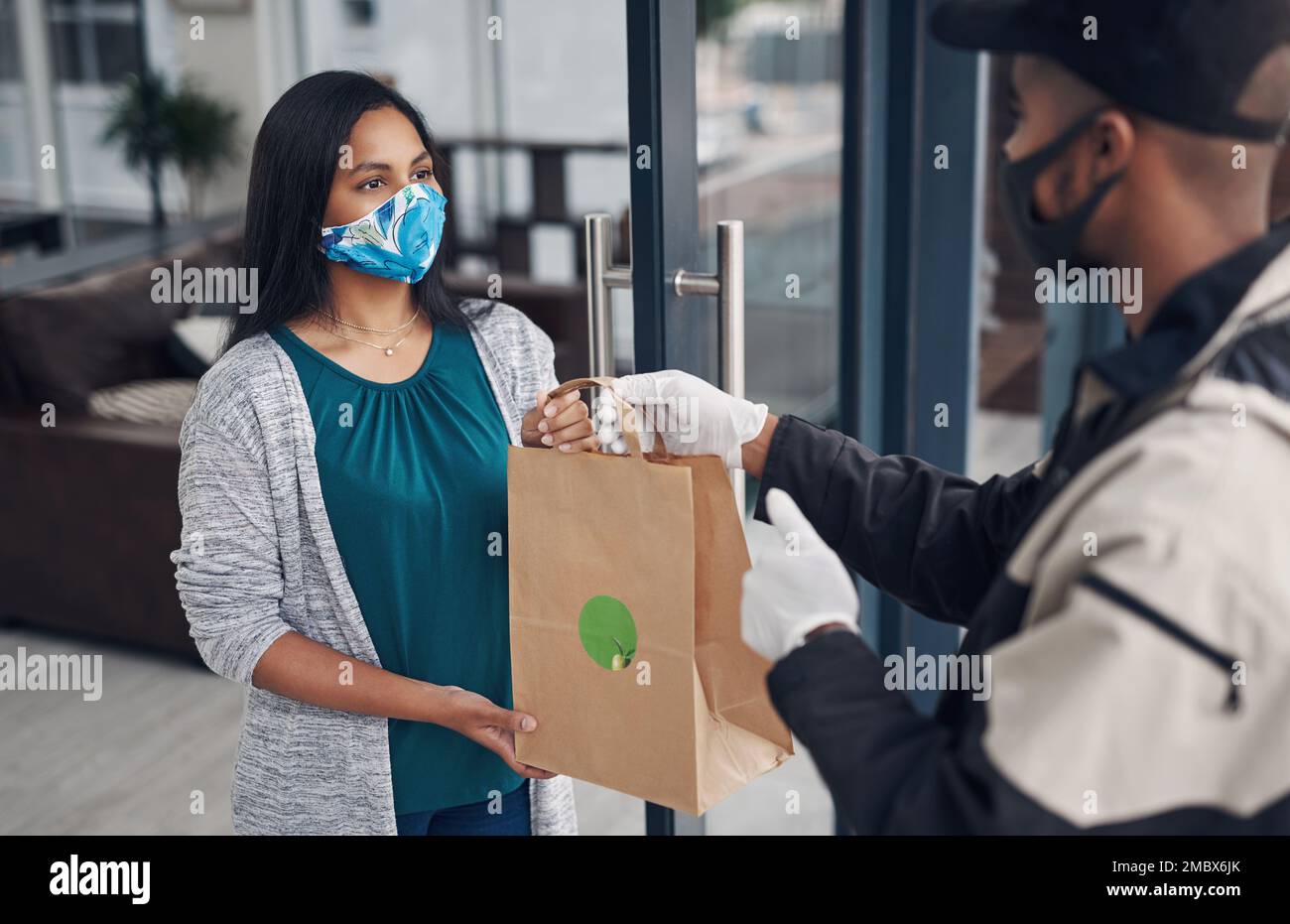 Fresh and safe, just what the customer ordered. a masked young woman ...