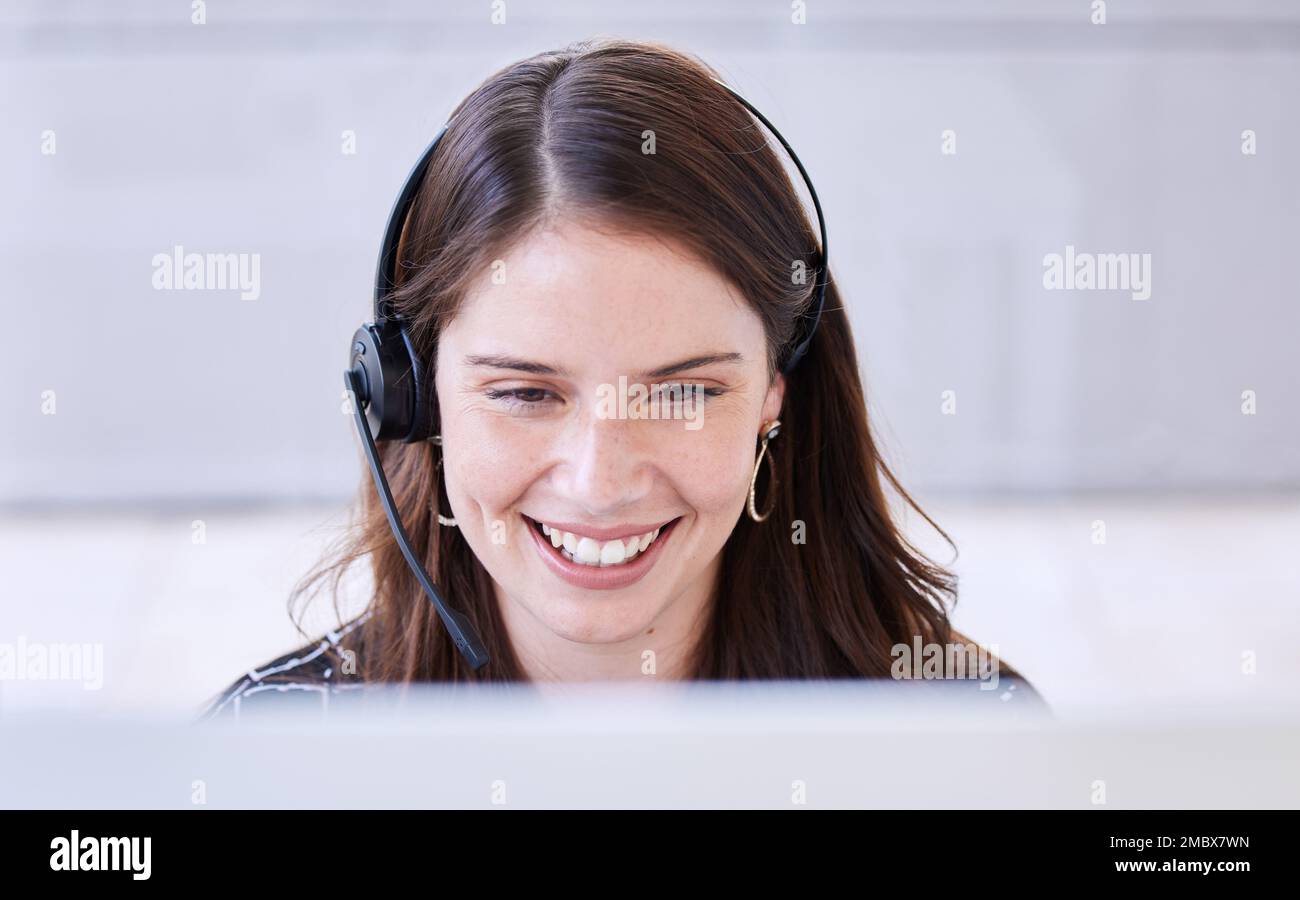 Woman, call center and smile with computer for customer service, advice and conversation while reading screen. Crm expert, consulting job or Stock Photo