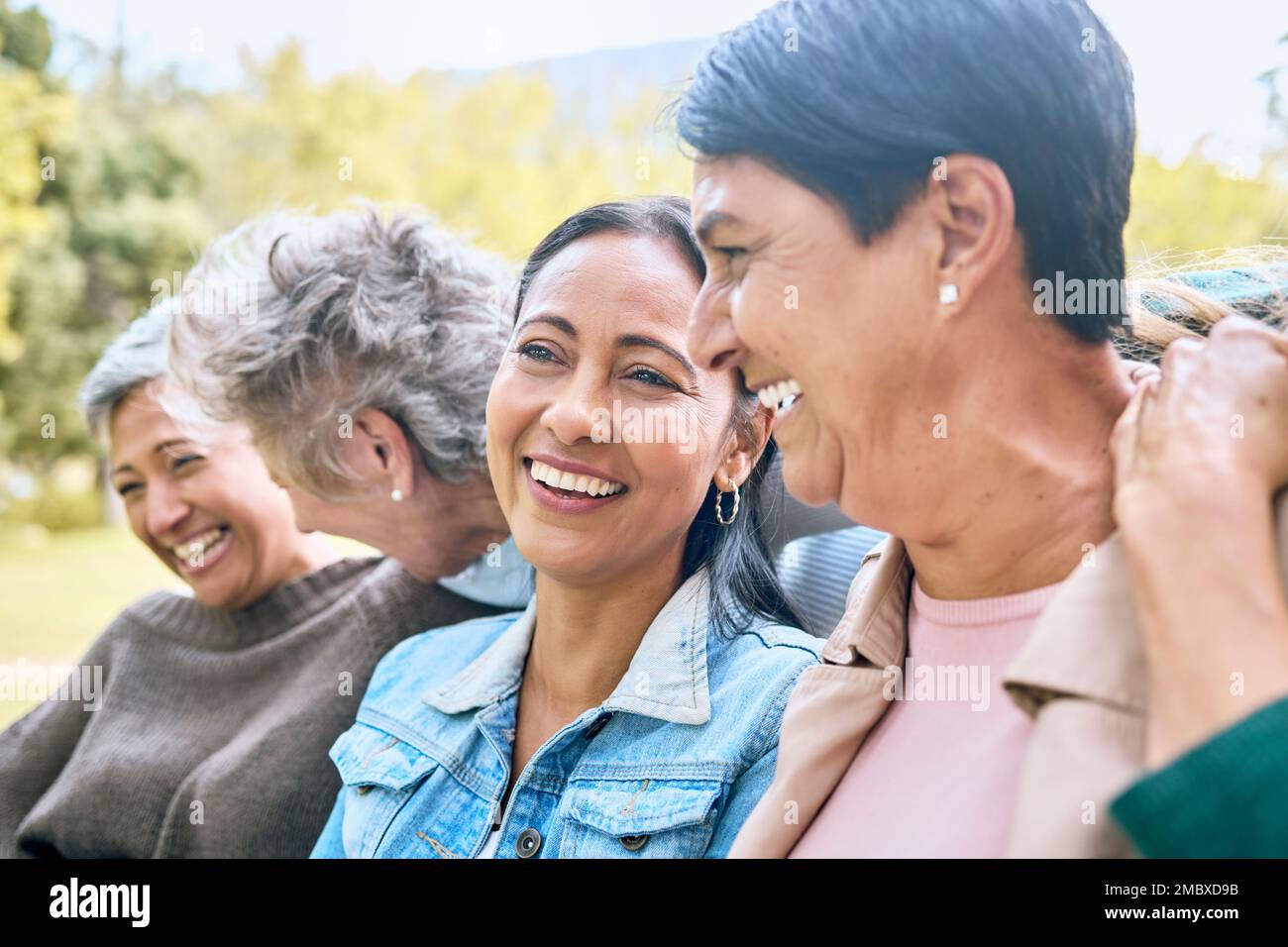 Friends, park and senior women laughing at funny joke, crazy meme or comedy outdoors. Comic, face and happy group of retired females with humor Stock Photo