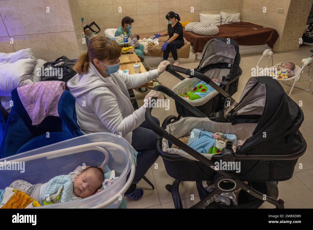 Nannies take care of newborn babies in a basement converted into a nursery  in Kyiv, Ukraine, Saturday, March 19, 2022. Nineteen surrogated babies were  born to surrogate mothers, with their biological parents