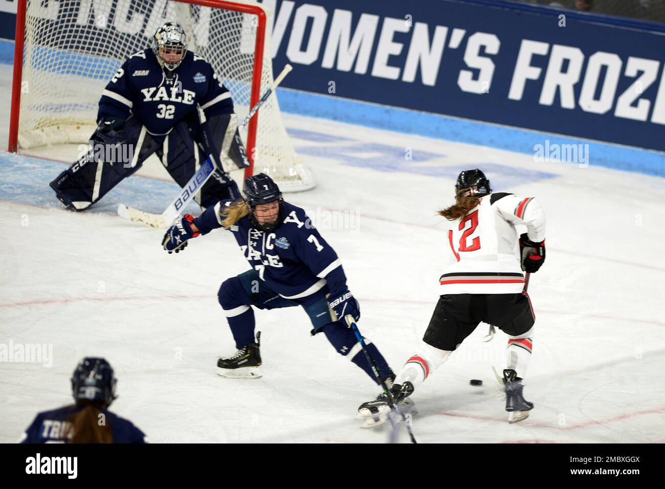 Ohio State's Jennifer Gardiner (12) attempts to get around Yale's Greta  Skarzynski (7) to take a shot on Yale goalie Gianna Meloni (32) during the  second period of an NCAA college women's