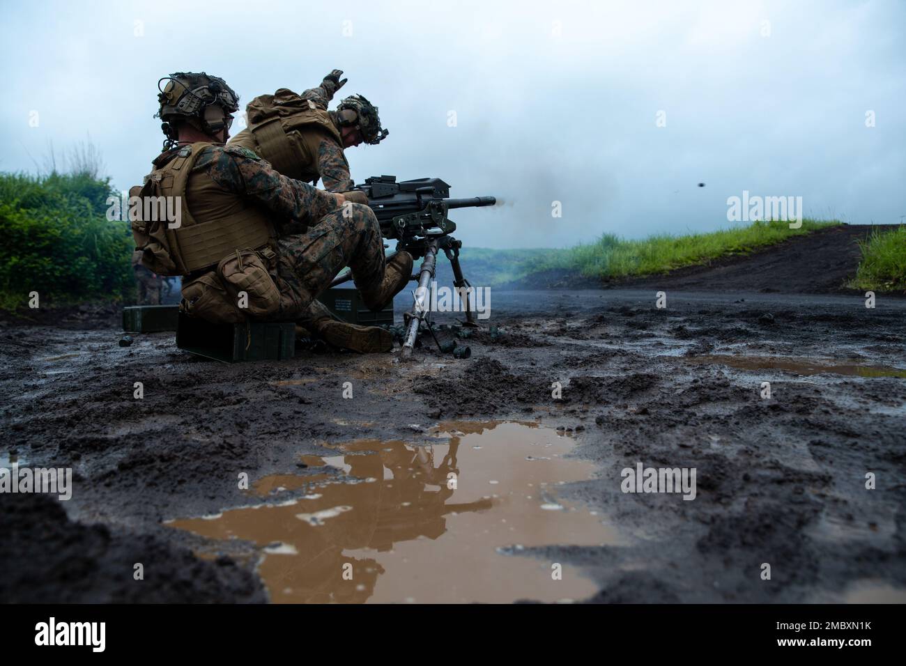 U.S. Marine Corps Cpl. John Cinnante (left) and Cpl. Tyler Somers (right), both machine gunners with 3d Battalion, 2d Marines fire a Mark 19 40 mm grenade machine gun during Exercise Shinka at Combined Arms Training Center, Camp Fuji, Japan, June 23, 2022. Shinka exemplifies a shared commitment to realistic training that produces lethal, ready, and adaptable forces capable of decentralized operations across a wide range of missions. 3/2 is forward deployed in the Indo-Pacific under 4th Marines, 3d Marine Division as part of the Unit Deployment Program. Stock Photo