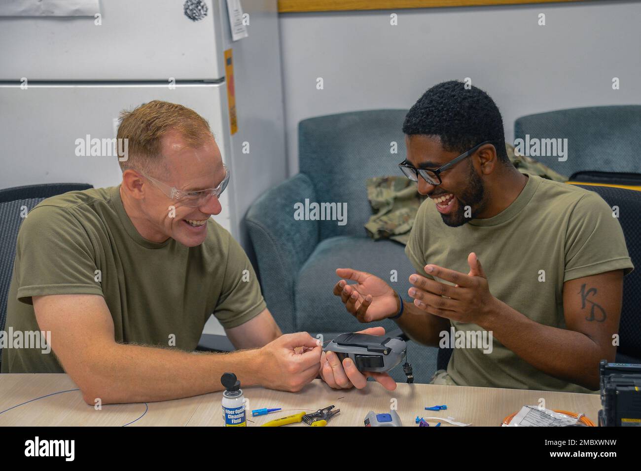 U.S. Air Force Col. Benjamin Jonsson, left, 6th Air Refueling Wing commander, and U.S. Air Force Senior Airman Davonte Love, a cable technician assigned to the 6th Communication Squadron (CS) splice a copper cable at MacDill Air Force Base, Florida, June 23, 2022. Jonsson visited the 6th CS to connect with airmen and gain a better perspective of their daily life. Stock Photo