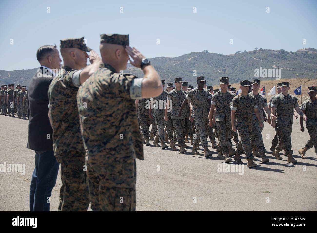 U.S. Marines with 1st Marine Regiment, 1st Marine Division, salute past and present commanding officers during the pass in review of a change of command ceremony at Marine Corps Base Camp Pendleton, California, June 23, 2022. During the ceremony, Col. Brandon Graham relinquished command of 1st Marine Regiment to Col. Brendan Sullivan. Stock Photo