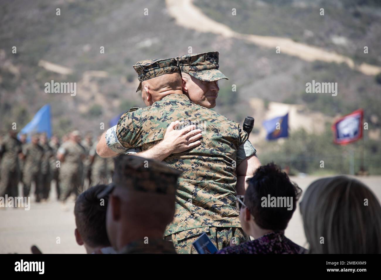 U.S. Marine Corps Col. Brandon Graham, the outgoing commanding officer of 1st Marine Regiment, 1st Marine Division (1st MARDIV), and Col. Brendan Sullivan, the incoming commanding officer of 1st Marine Regiment, 1st MARDIV, embrace during a change of command ceremony at Marine Corps Base Camp Pendleton, California, June 23, 2022. During the ceremony, Graham relinquished command of 1st Marine Regiment to Sullivan. Stock Photo
