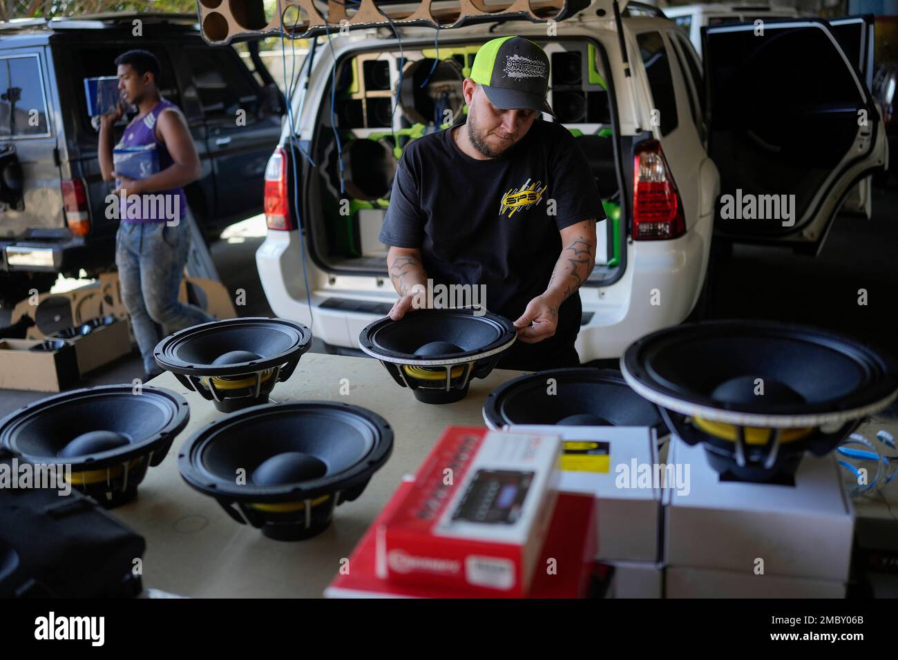 Ruben Marchan puts led lights on a speaker at the CBC Car Audio