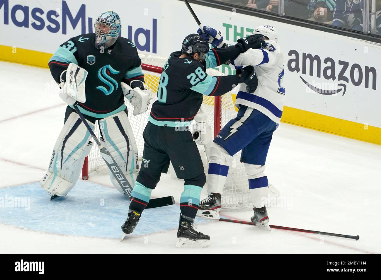 Seattle Kraken goaltender Philipp Grubauer, left, stands by the goal as