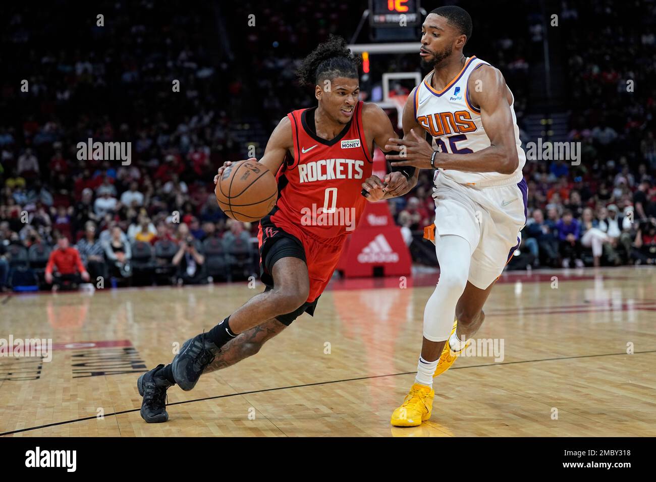 Houston Rockets' Jalen Green (0) drives toward the basket as Phoenix Suns'  Mikal Bridges (25) defends during the first half of an NBA basketball game  Wednesday, March 16, 2022, in Houston. (AP