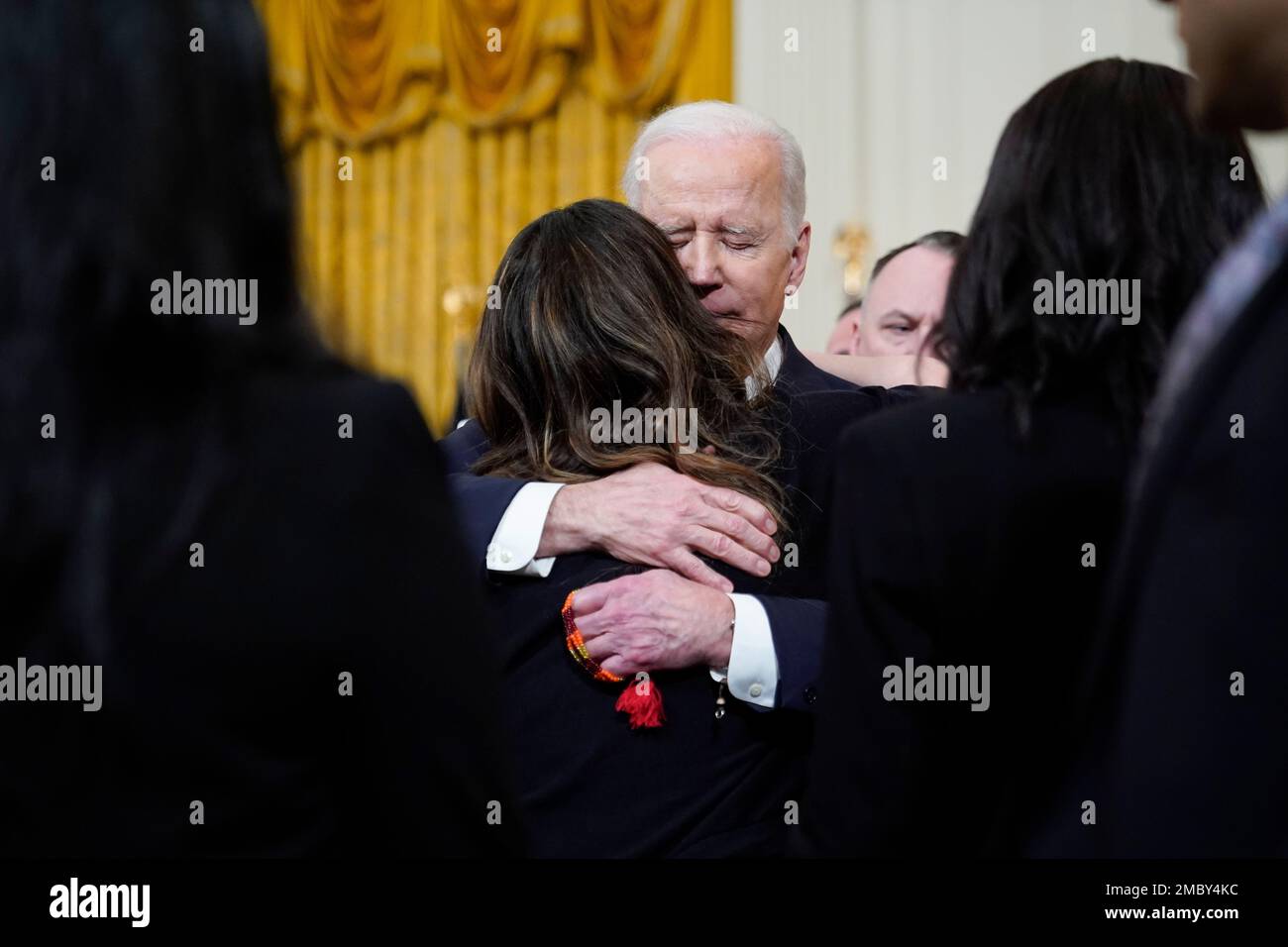 President Joe Biden hugs Kathy Sherlock, mother of Kayden Mancuso, a 7 ...