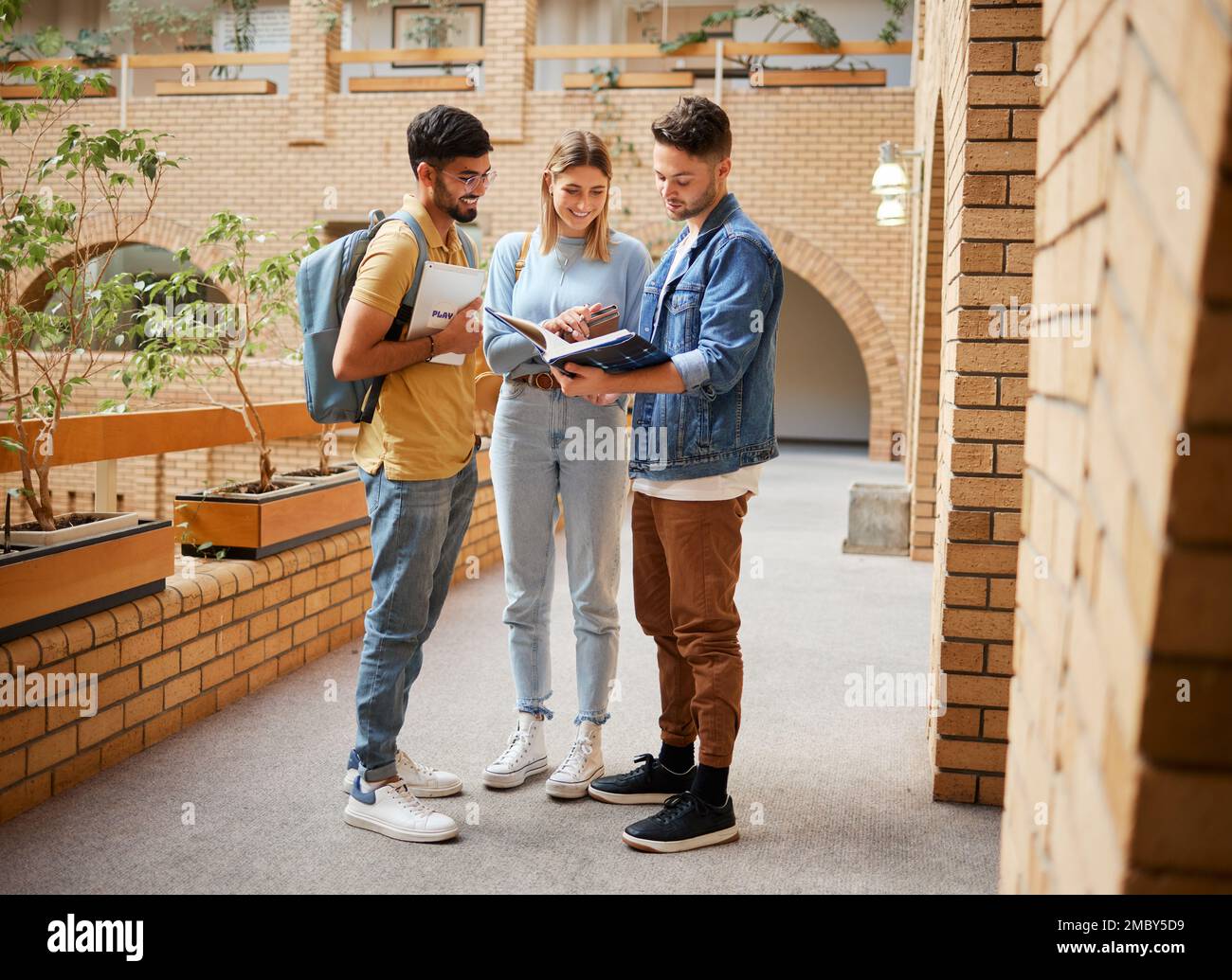 University, students and friends with textbook for project study