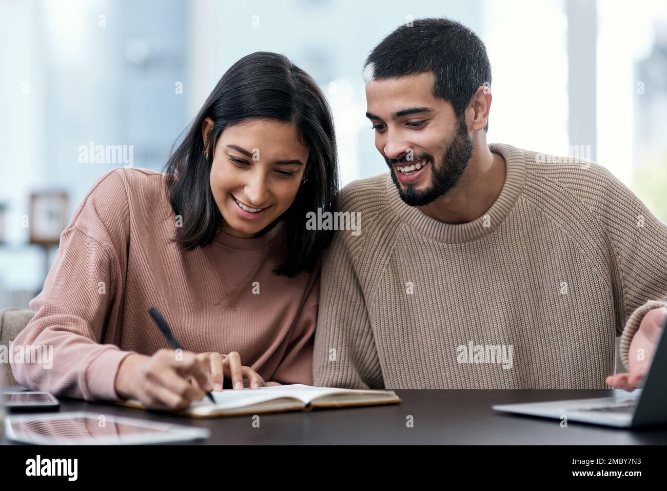 Stay organised, stay the quarantine course. a young couple going over ...