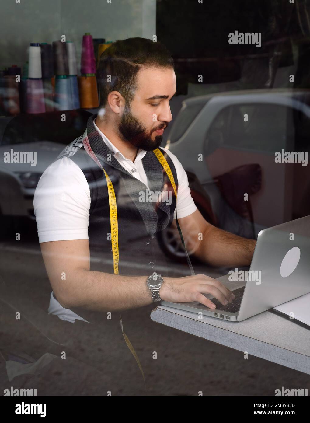 Tailor man working at his atelier Stock Photo