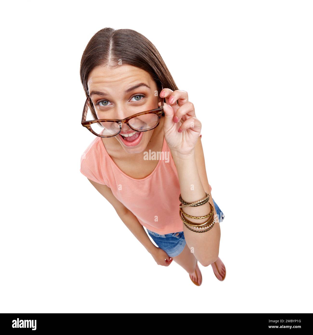 Woman, comedy and portrait of a model with glasses, smile and casual fashion being silly. White background, happiness and isolated young person Stock Photo