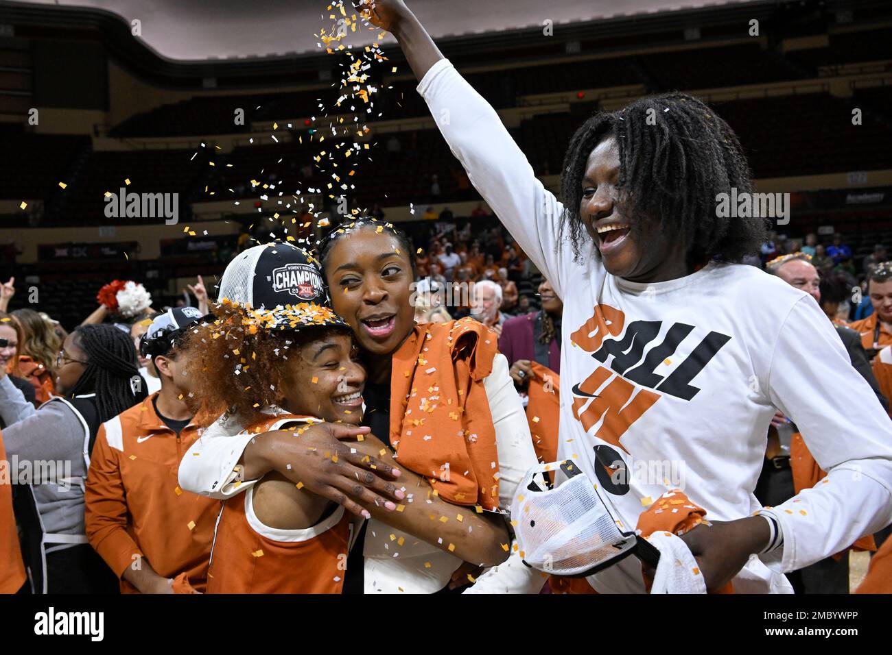 Texas guard Rori Harmon, lower left, is showered with confetti by teammate  Femme Masudi while hugging associated head coach Dinah Jackson after the  NCAA college basketball championship game against Baylor in the