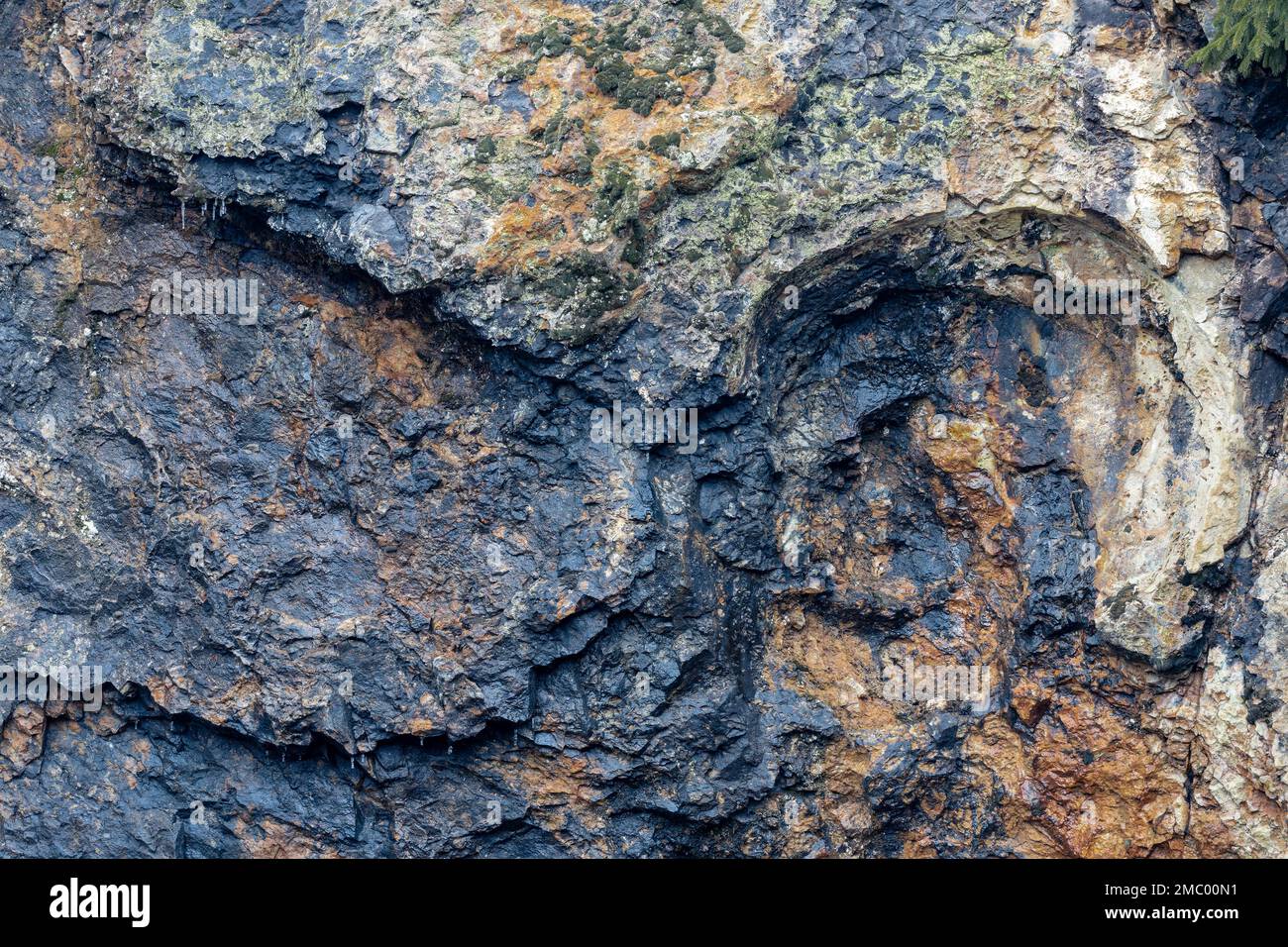 Colorfull stone wall containing minerals. Stock Photo
