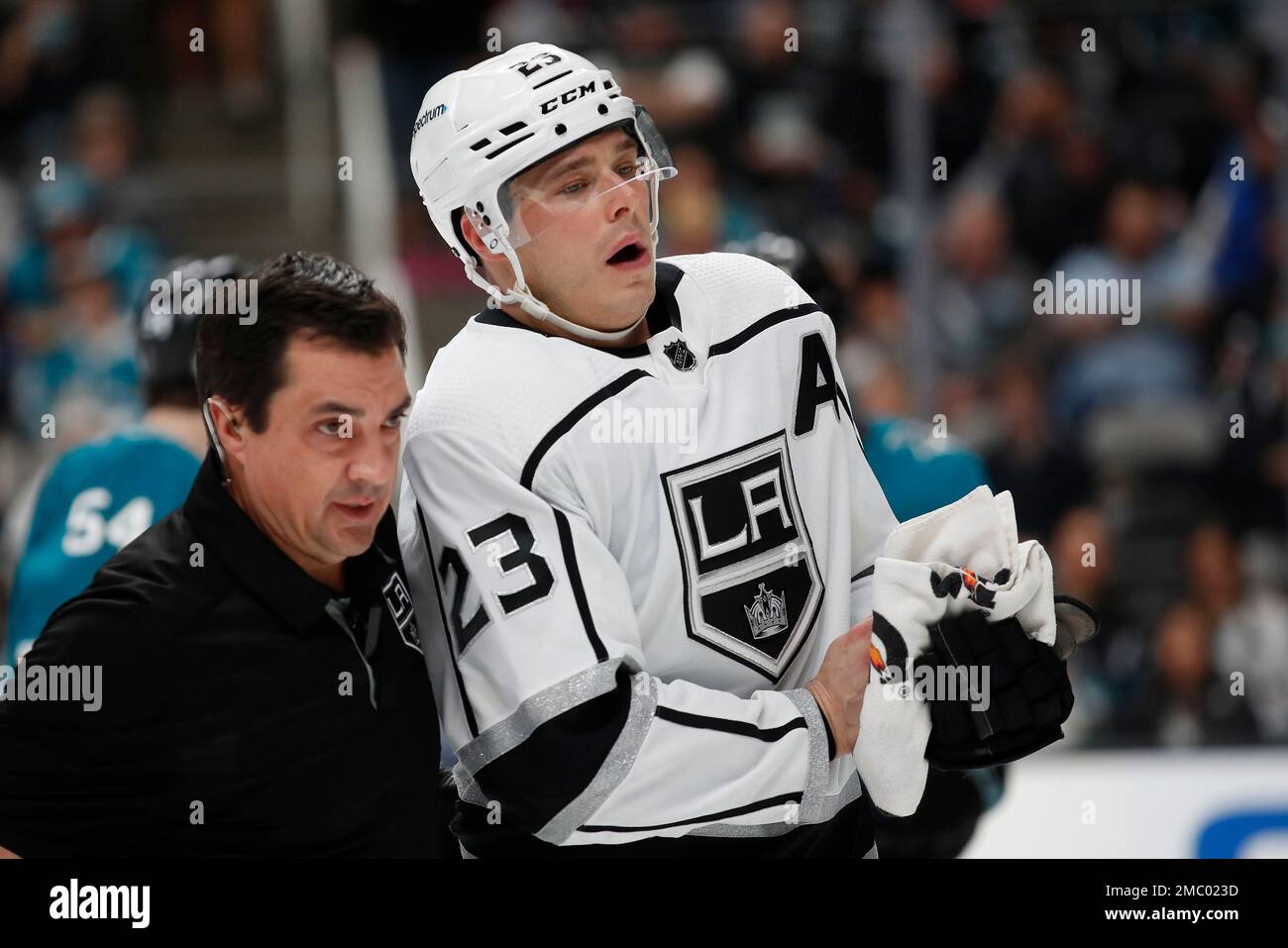 Los Angeles Kings head athletic trainer Chris Kingsley, left, escort right  wing Dustin Brown (23) during the second period of an NHL hockey game  against the San Jose Sharks in San Jose,