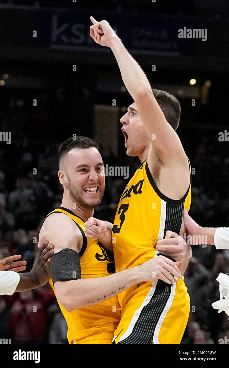 Iowa's Jordan Bohannon (3) celebrates in the arms of Connor McCaffery after  Bohannon hit the game-winning shot during the second half of an NCAA  college basketball game against Indiana in the semifinal