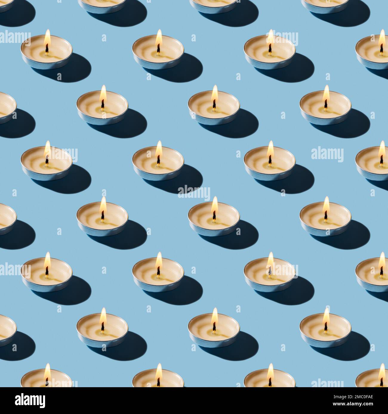 Seamless pattern of burning tea light candles. Lit candle casts shadow ...