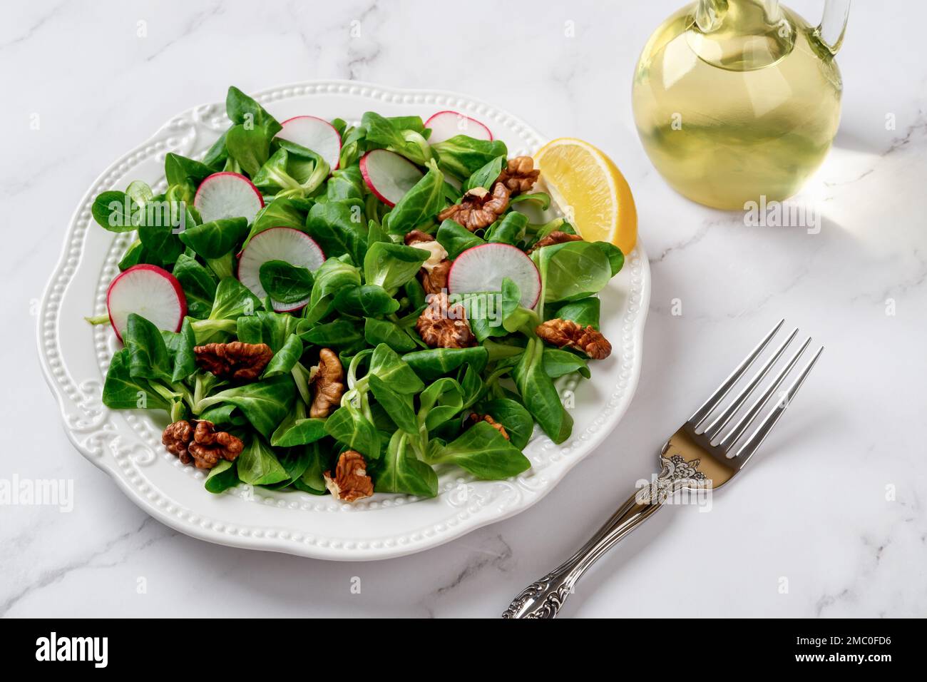Lambs lettuce salad with radish and walnuts. Cornsalad leaves, nut