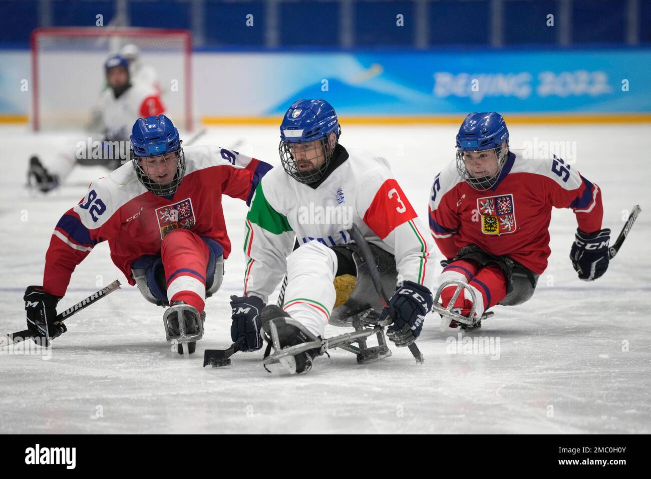 Italy's Gianluigi Rosa, center, battles for the puck against Czech  Republic's Patrik Sedlacek,left, and Filip Vesely during their para ice  hockey match for the fifth place at the 2022 Winter Paralympics, Friday,