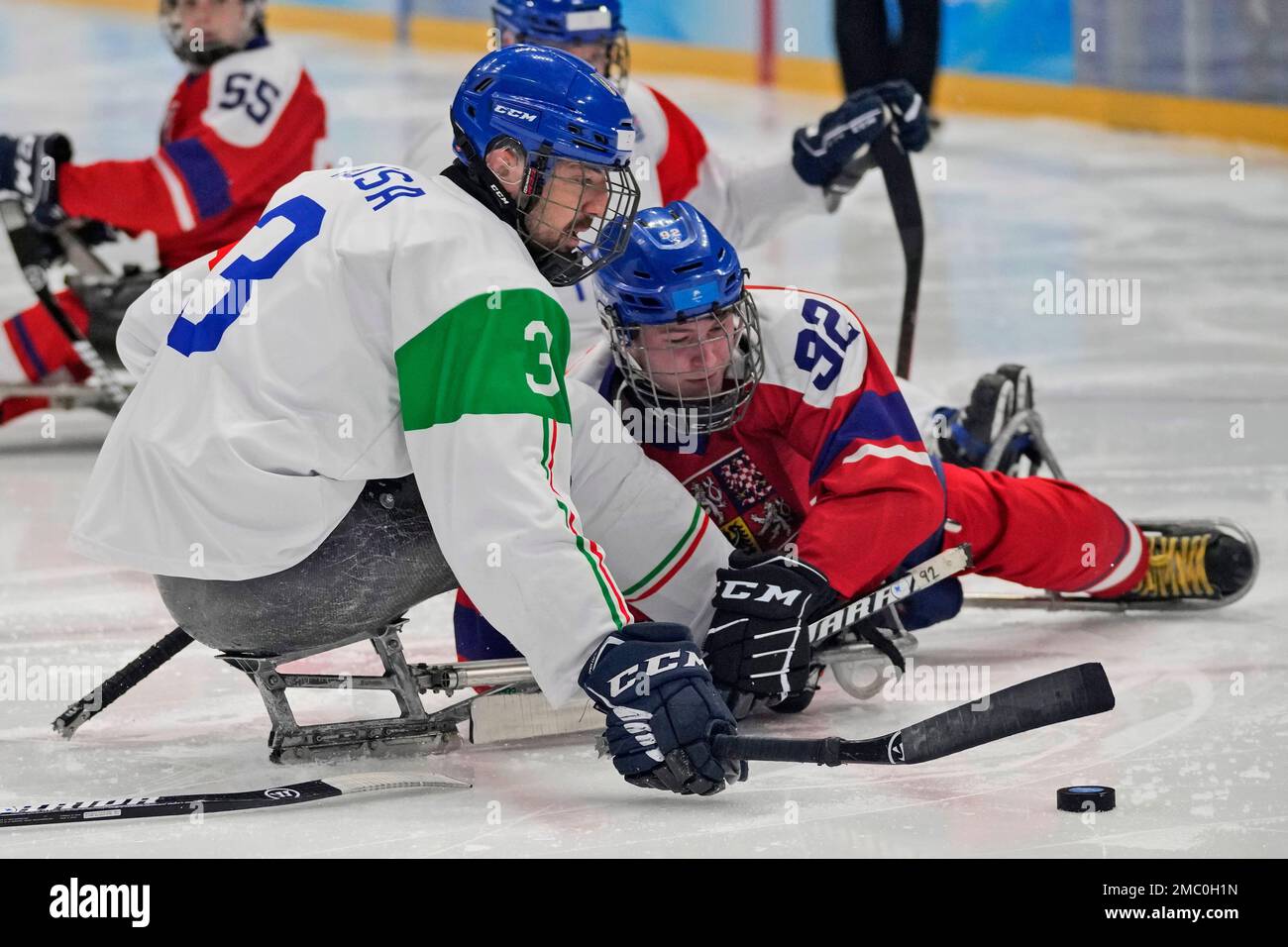 Italy's Gianluigi Rosa, left, battles for the puck against Czech Republic's  Patrik Sedlacek during their para ice hockey match for the fifth place at  the 2022 Winter Paralympics, Friday, March 11, 2022,