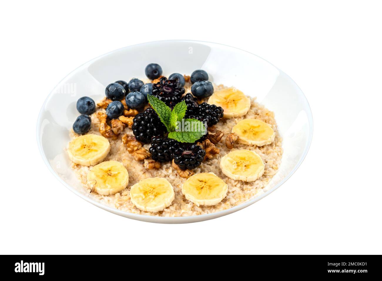 Bowls of oatmeal with berries and fruits on isolated white background Stock Photo