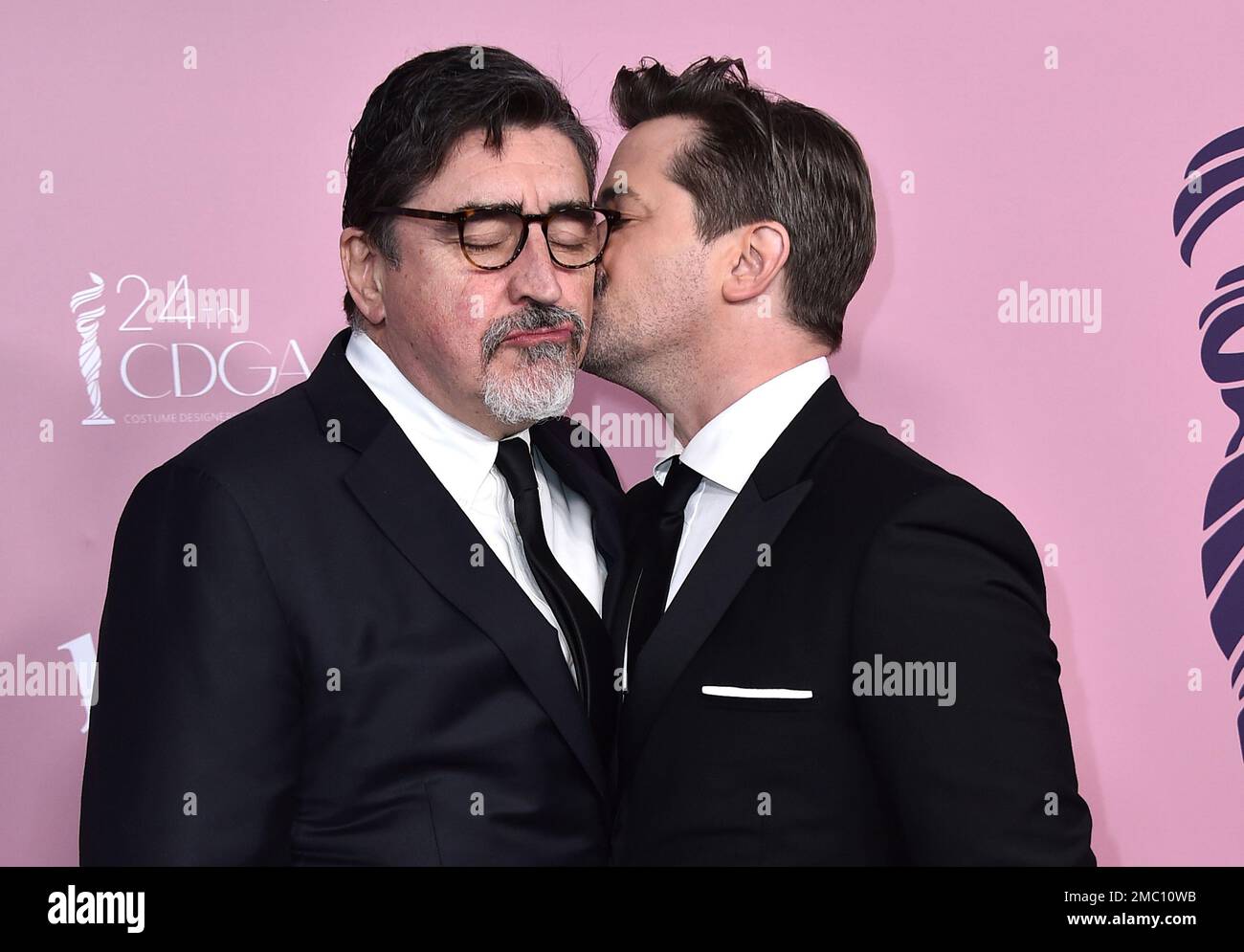 Andrew Rannells, right, kisses Alfred Molina as they arrive at the 24th(00)