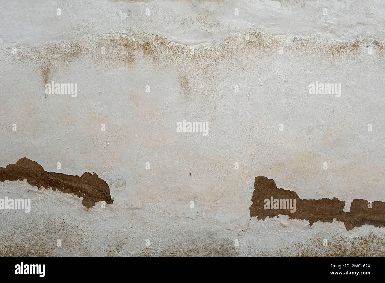 Old weathered white limewashed wall background Stock Photo