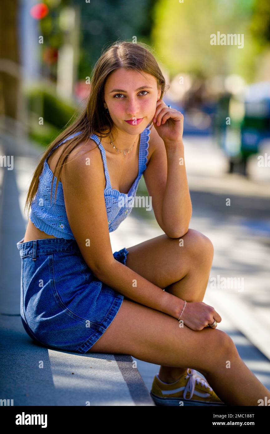 Teenage Girl Sitting on Steps in Front of City Hall Plaza in Downtown